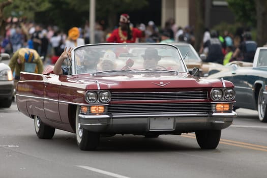 Louisville, Kentucky, USA - May 03, 2018: The Pegasus Parade, a Cadillac Caddy classic car, going down W Broadway during the Parade