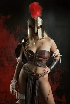 Ancient woman warrior or Gladiator posing in a dark background