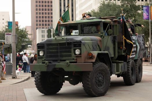 Houston, Texas, USA - November 11, 2018: The American Heroes Parade, A M939 series 5-ton 6x6 truck, Military truck carrying the american flag and members of the green berets