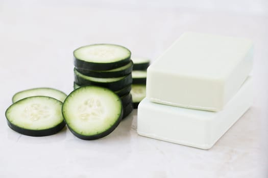 Cucumber slices and soap with cucumber extract.