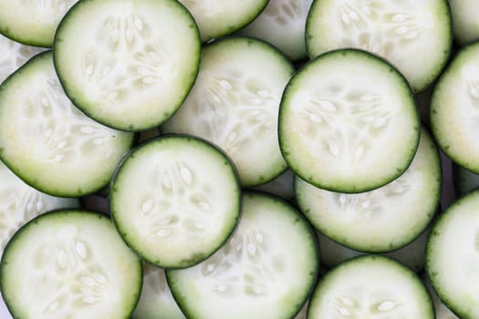 Cucumber slices filling frame for food background.