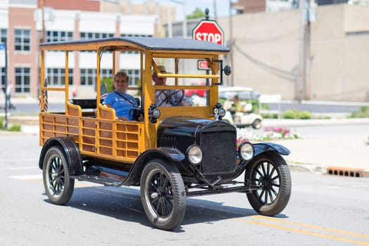 Kokomo, Indiana, USA - June 30, 2018: Haynes Apperson Parade, Old Ford Classic Truck carrying the American flag and driving down the street