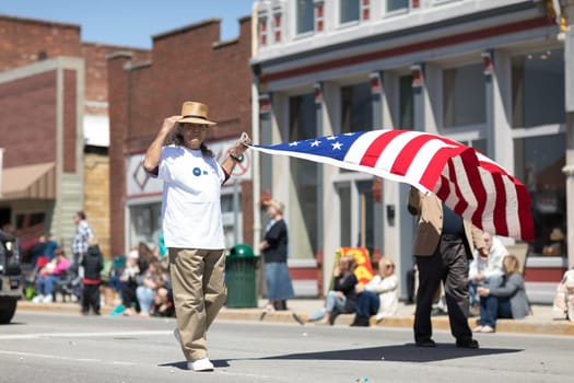 Orleans, Indiana, USA - April 28, 2018: The Orleans DogWood Festival and Parade, two men carrying the american flag during the parade