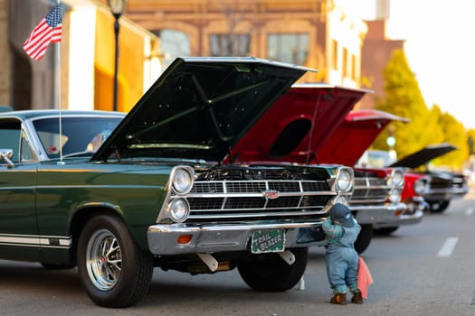 Springfield, Illinois, USA - September 22, 2018: The Route 66 Mother Road Festival, Ford Fairlane GT with a pair of dolls on the streets of downtown Springfield
