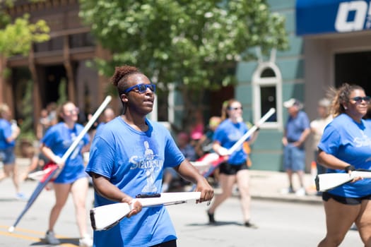 Kokomo, Indiana, USA - June 30, 2018: Haynes Apperson Parade, The Kokomo High School Marching Wildkats performing at the parade and wearing shirts that say Statuesque