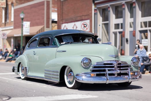 Orleans, Indiana, USA - April 28, 2018: The Orleans DogWood Festival and Parade, A classic car going down the street during the parade, a Chevrolet Fleetline color green