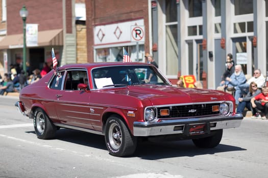 Orleans, Indiana, USA - April 28, 2018: The Orleans DogWood Festival and Parade, A classic car going down the street during the parade a Chevrolet Nova 350 color Red