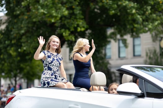 Auburn, Indiana, USA - September 9, 2018 The Auburn Cord Duesenberg Festival, Beauty contestants on a car going down the street waving at espectators