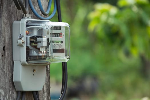 Electric power meter measuring power usage. Watt hour electric meter measurement tool with copy space.