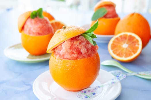 Refreshing orange sorbet served in a fresh blood orange