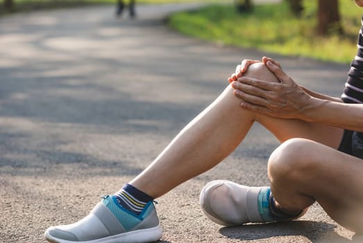 The female clings to a bad leg. The pain in her leg. Health and painful concept.