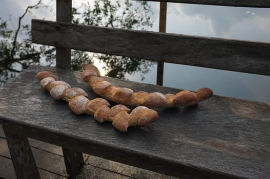 Two baguettes on the wooden chair  background . Concept Nature food , Organic food