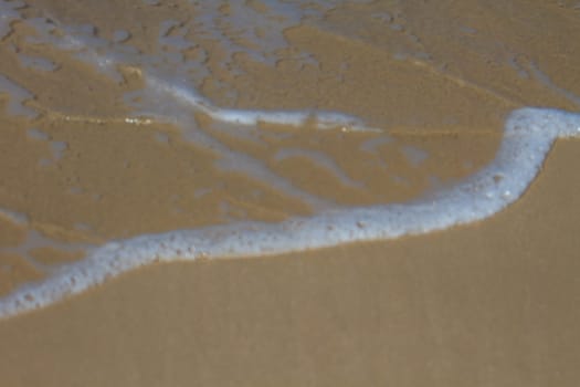 Moving of surf in the sea,Soft wave of the sea on the sandy beach