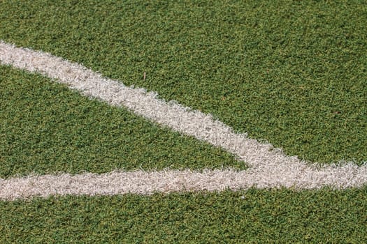 White stripe on the green soccer field from top view