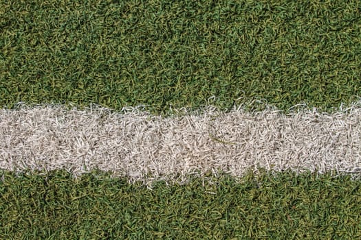 White stripe on the green soccer field from top view