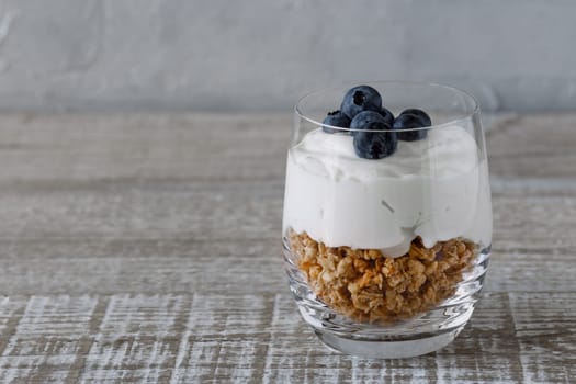 Granola with yogurt and blueberriesGranola with yogurt and blueberries in a glass beaker