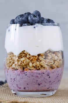 Granola with yogurt and blueberriesGranola with yogurt and blueberries in a glass beaker