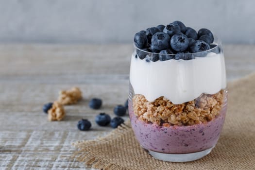 Granola with yogurt and blueberriesGranola with yogurt and blueberries in a glass beaker