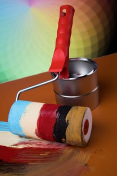 Tin cans with paint, brushes and bright palette of colors