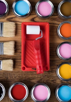 Metal tin cans with color paint and paintbrush