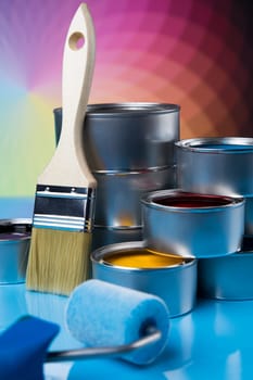 Tin cans with paint, brushes and bright palette of colors