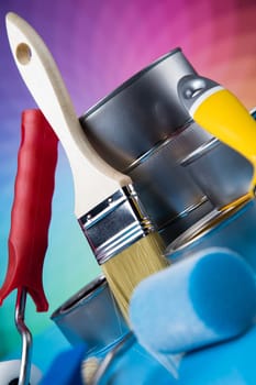 Paintbrush on cans with color