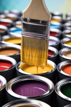 Metal tin cans with color paint and paintbrush