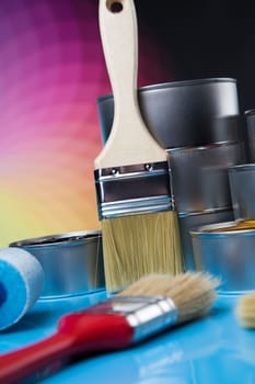 Metal tin cans with color paint and paintbrush