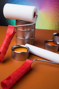 Paintbrush on cans with color