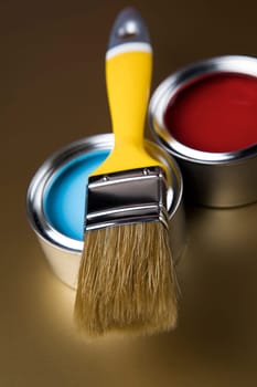 Tin cans with paint, brushes and bright palette of colors