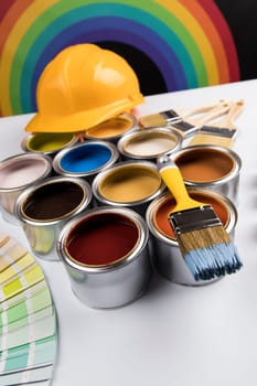 Metal tin cans with color paint and paintbrush