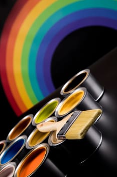 Metal tin cans with color paint and paintbrush