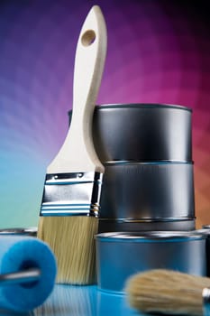 Tin cans with paint, brushes and bright palette of colors
