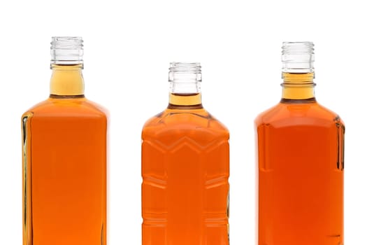 Glass bottle of whiskey on a white background