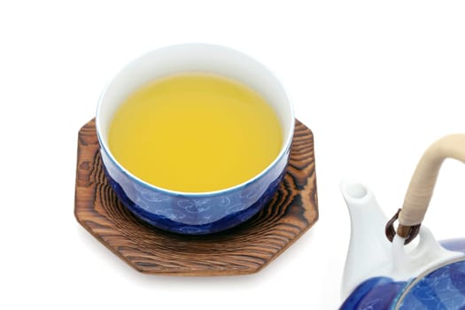 Green tea in a japanese tea set with cup and pot