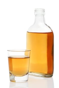 Glass cup and bottle of whiskey on white background