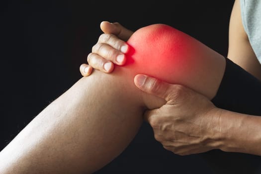 The male clings to a bad knee. The pain in his knee. Health and painful concept.