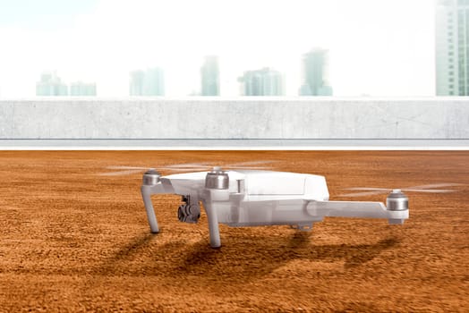 White drone with camera on the rooftop ready to flying to the air with skyscrapers background