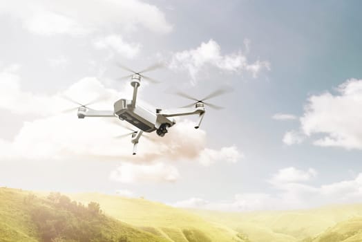 White drone with camera flying above green hills with blue sky background