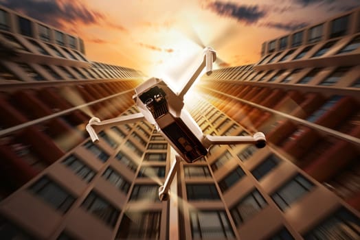 White drone with camera flying to the top of modern building with sunset background