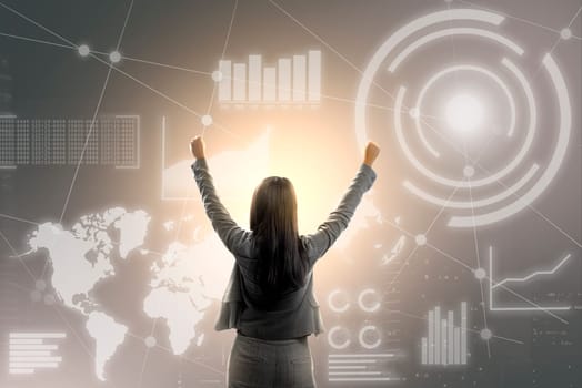 Rear view of asian business woman touch virtual screen which display the interface of financial chart and world maps. Digital technology concept