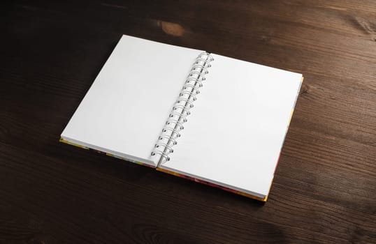 Blank notepad mock up on wooden background.