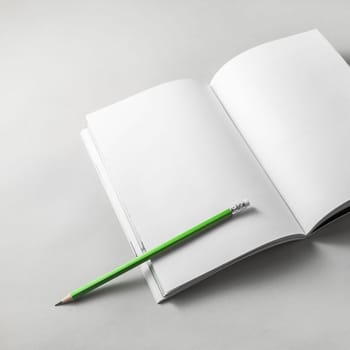 Blank brochure or nagazine and pencil on paper background. Mock-up on soft gray background.