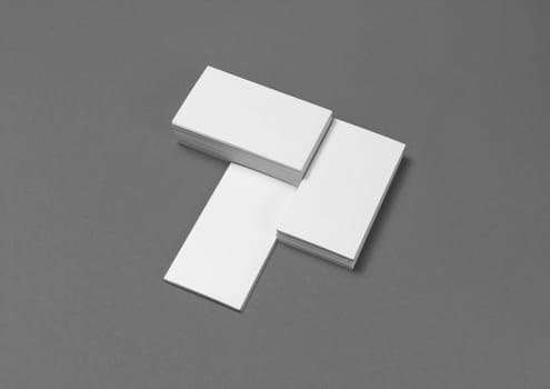 Mockup of blank business cards on gray paper background.