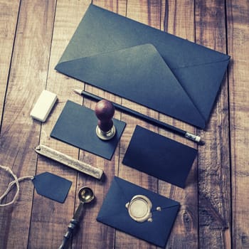 Blank black stationery template on vintage wooden background. Mock up for branding identity.
