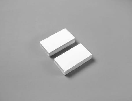 Blank business cards mockup on gray paper background. Copy space for text.