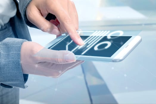 Business woman touch the digital tablet and display the interface of chart and graphs. Digital technology concept