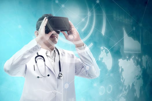 Asian male doctor in white coat and stethoscope using virtual reality device and looking at virtual screen which display the interface of financial chart and world maps. Digital technology concept