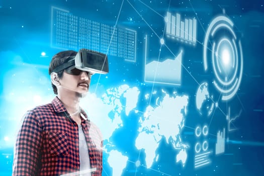Asian man looking at digital interface with virtual reality device display the world map, graphic bar and binary code. Augmented reality technology