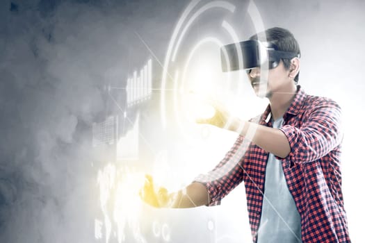 Asian man touching a circle and world map on digital interface with virtual reality device display the world map, graphic bar and binary code. Augmented reality technology